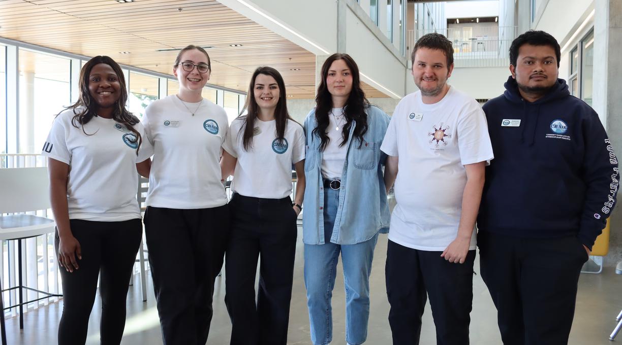 Six Vancouver Island University students standing inside a building