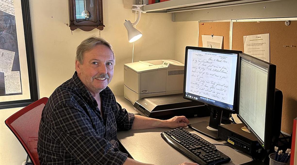 Stephen sits at his computer