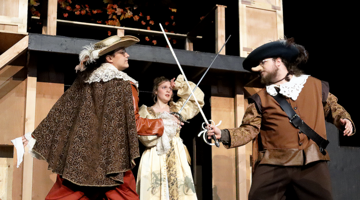 Three of the actors stage a swordfighting scene for their production Cyrano de Bergerac.