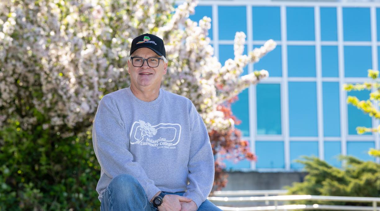 David Butler sitting outside on a sunny day.