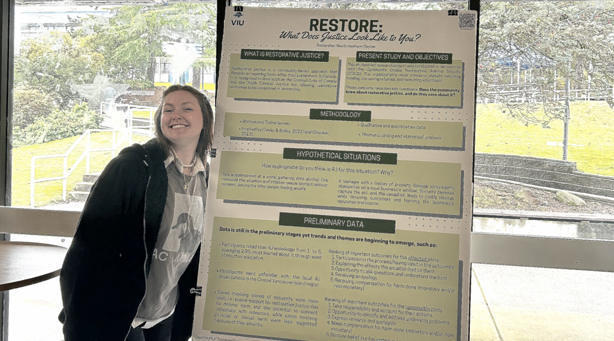 Madelyn in the cafeteria with her research poster