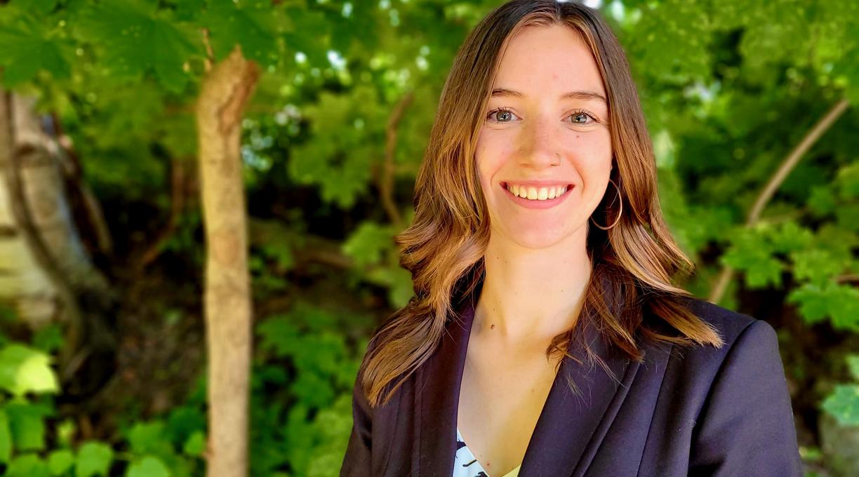 Megan Fortune in front of green foliage