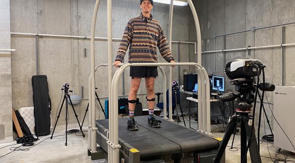 A male university student is walking on a treadmill for research 