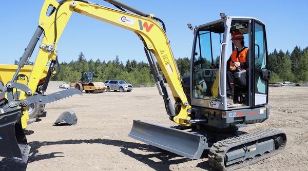 a person operates an excavator