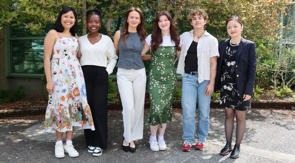 Six Vancouver Island University students standing together in front of a bush