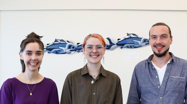Simon Maguire, Lily Eggert and Trevor Michalchuk stand side-by-side smiling.
