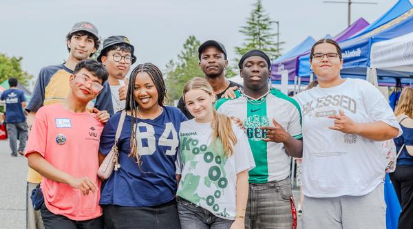 Group photo of students with tents in the background