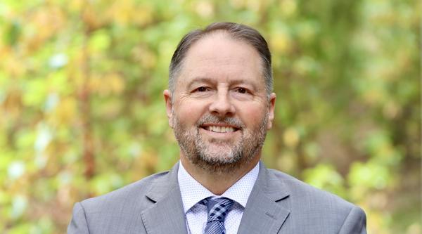 Dennis Johnson with a forest background