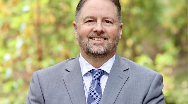 Dennis Johnson with a forest background