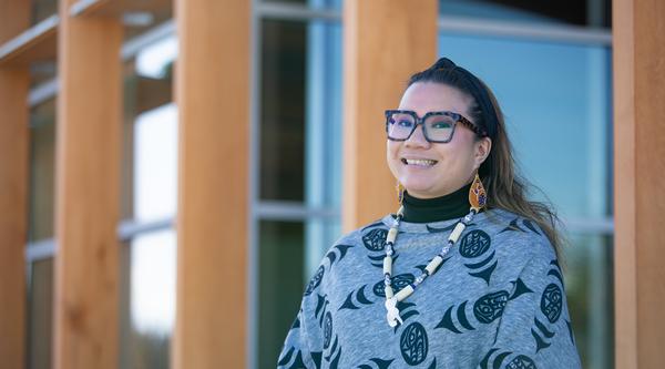 Leah stands in front of gathering place