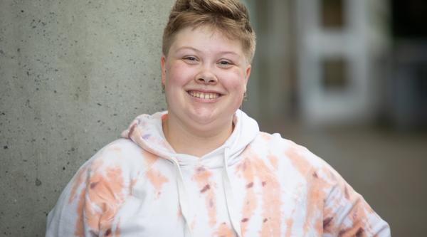 Tatum poses in front of a grey wall