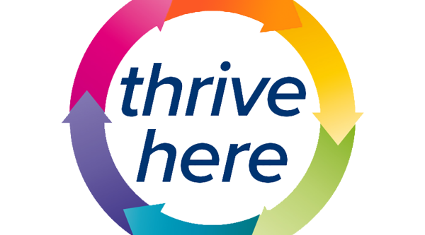 rainbow circle with arrows making the colours that says Thrive Here in the middle