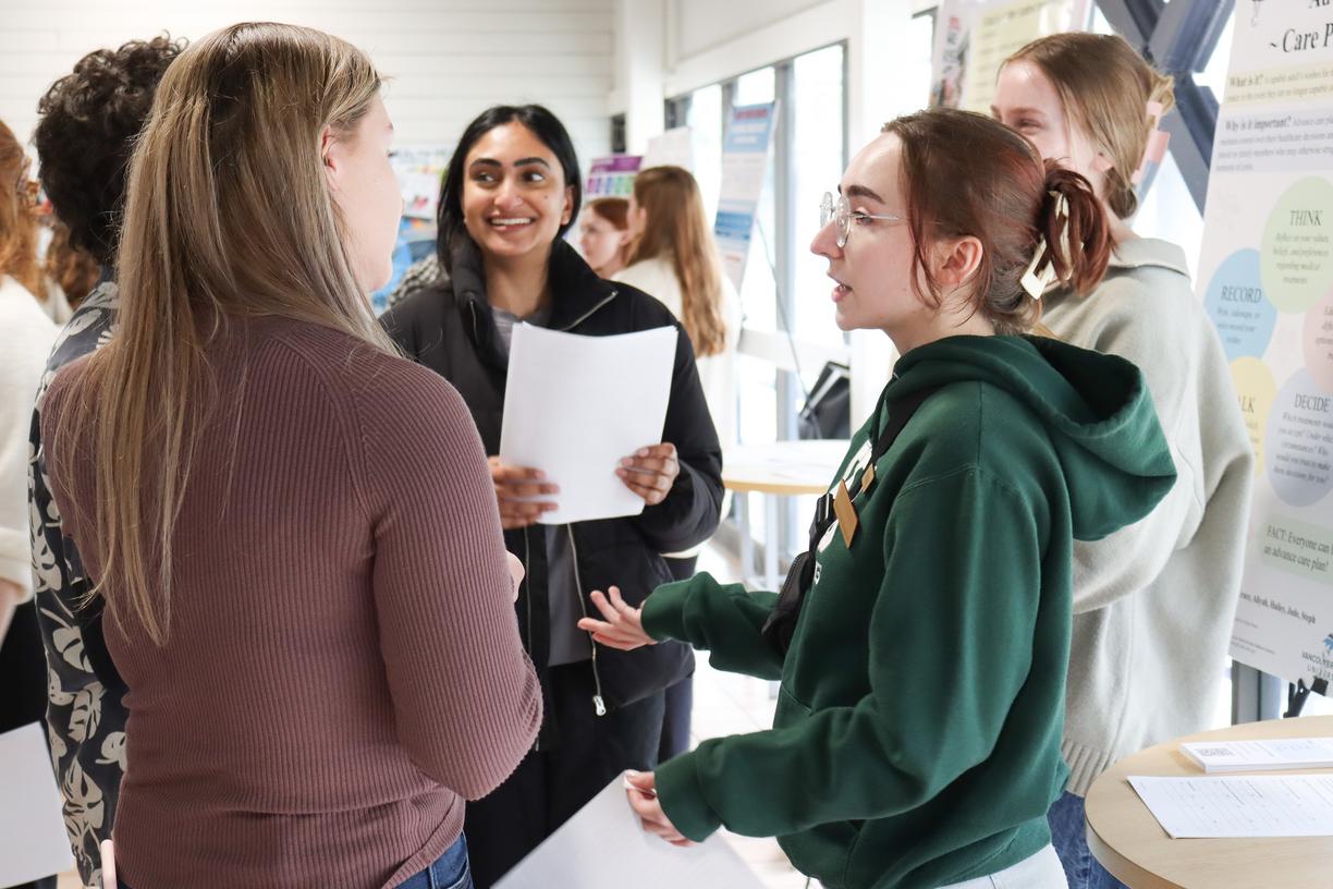 Five students talk to each other at CREATE conference