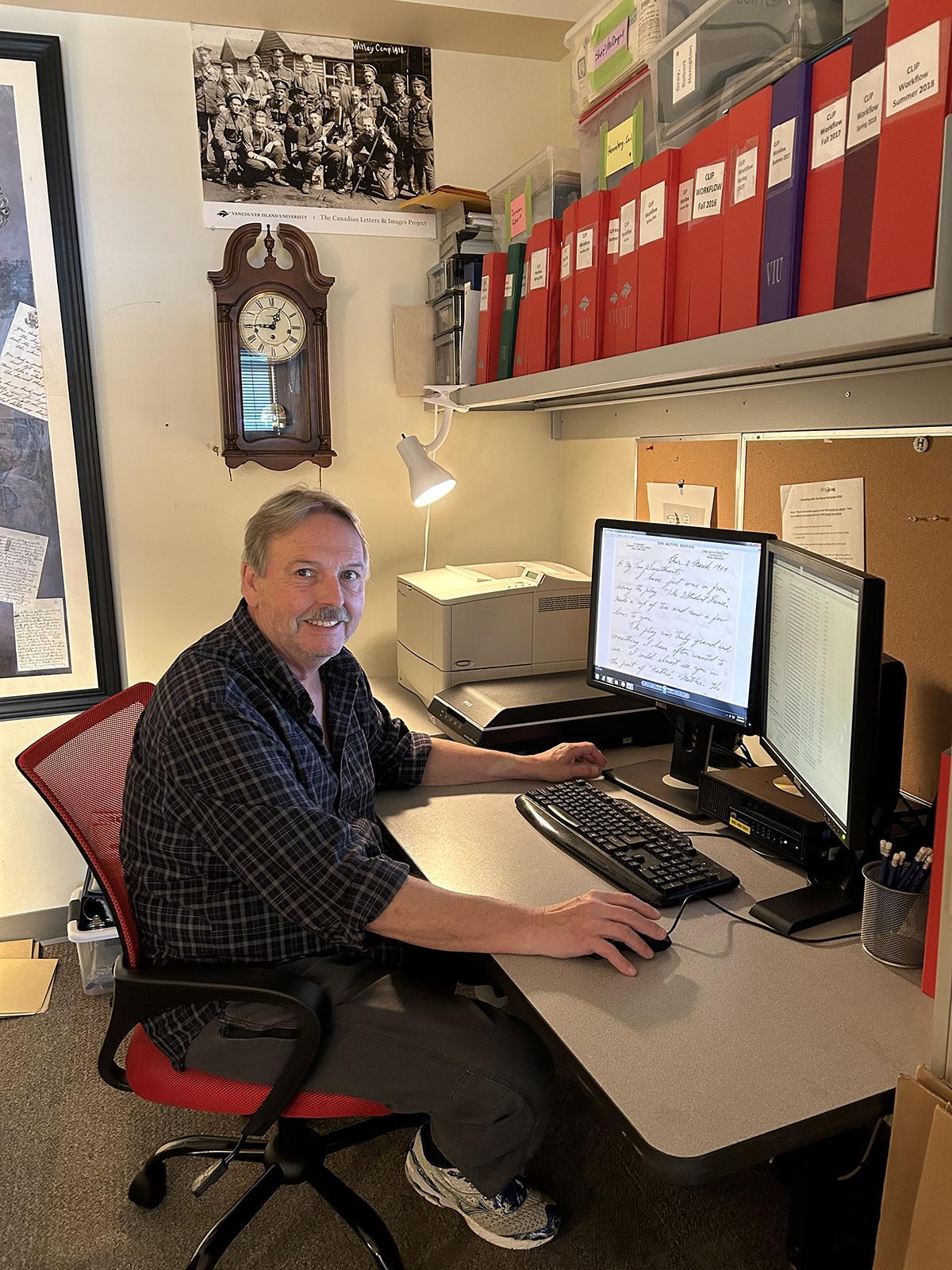 Stephen sits at his computer