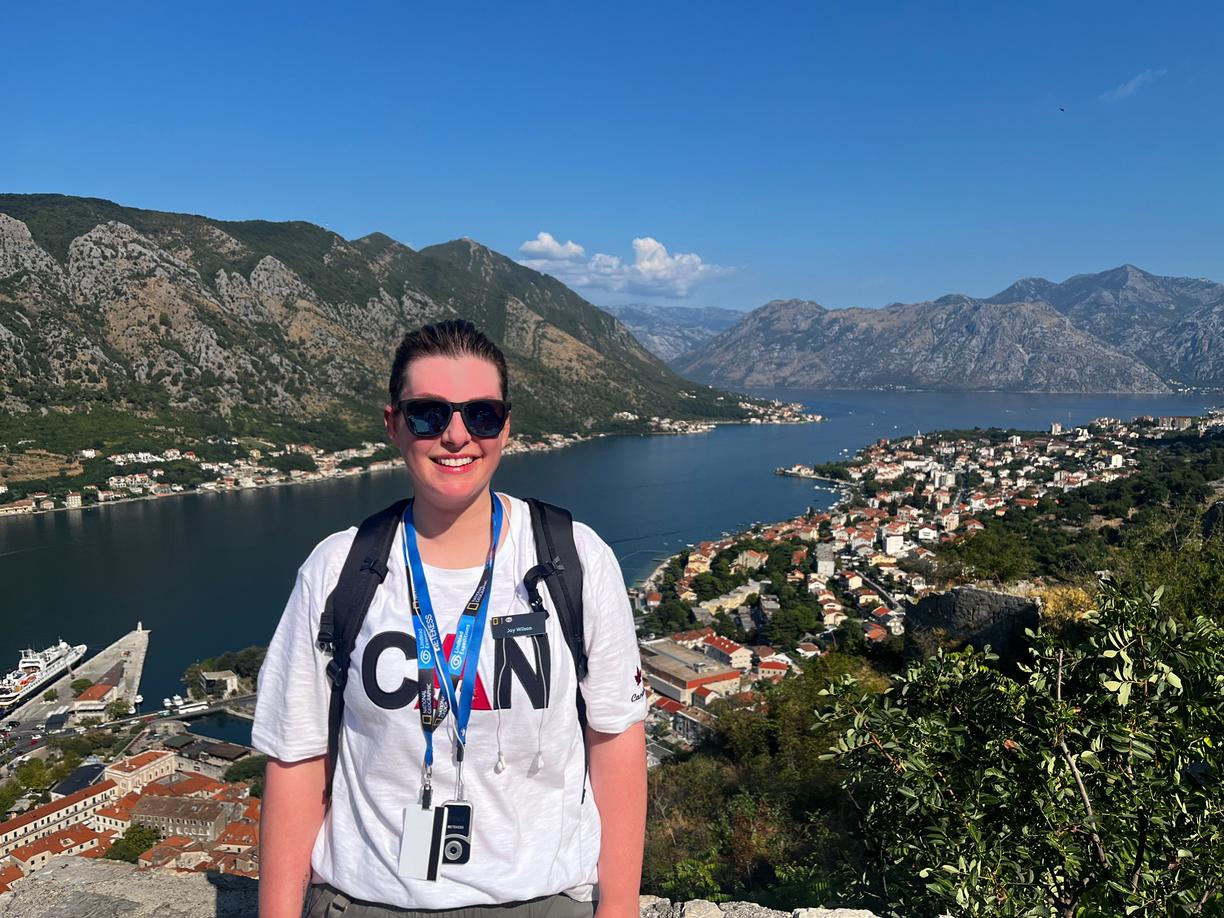 A woman with a beautiful vista view behind her