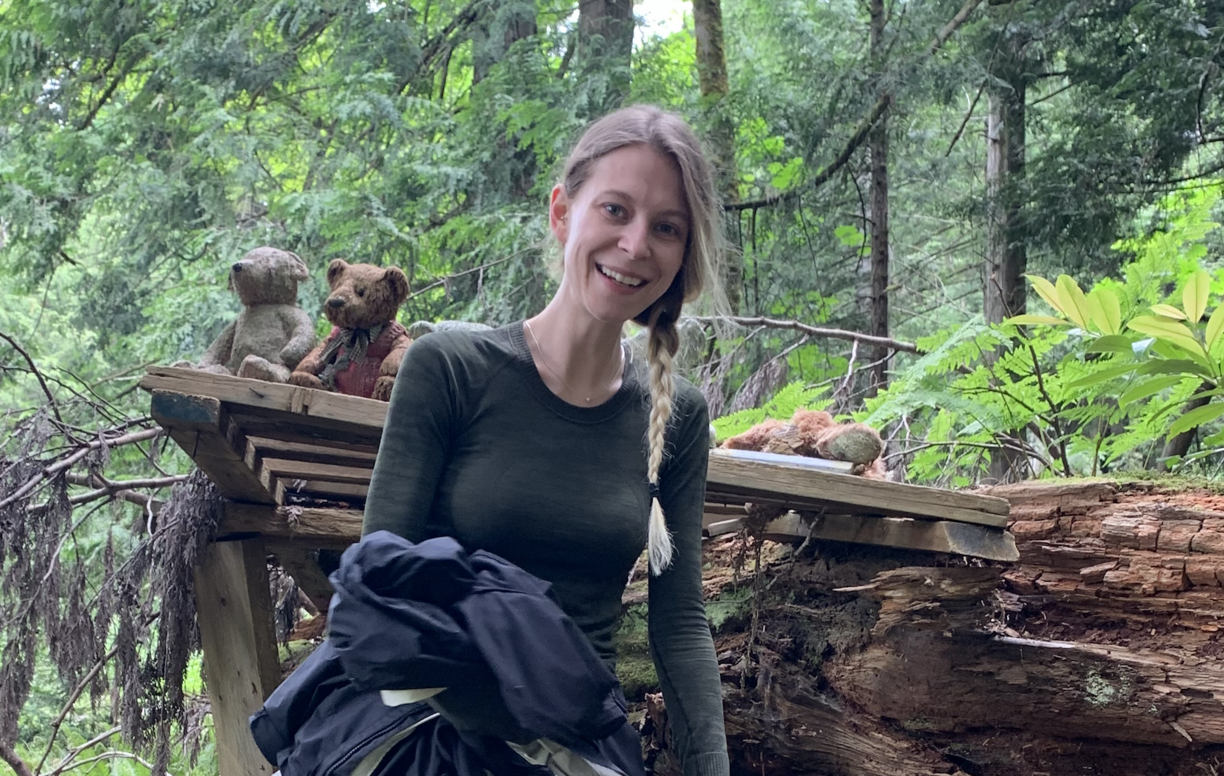 Isabelle Desrosiers in a green forest and smiling at the camera.
