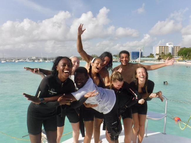 a group of people in front of an ocean