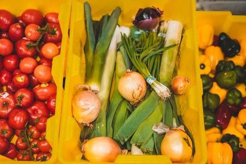 crates of fresh food including onions and tomatoes
