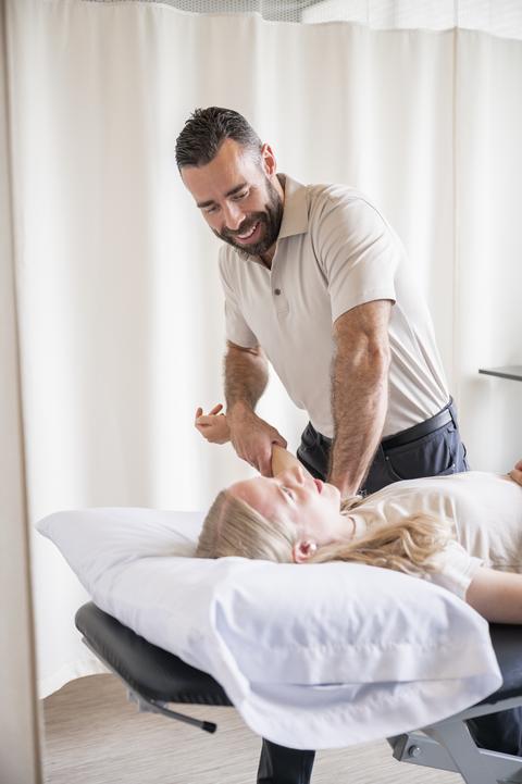 Jake helps a client on a physio table