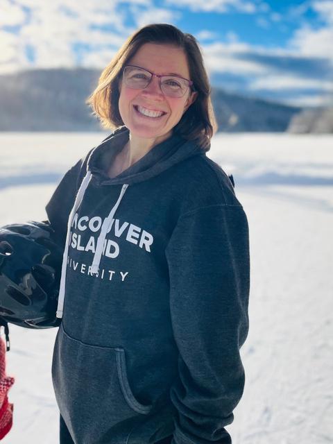 Katharine Rollwagen wearing a VIU sweater with a snowy background