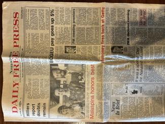 a newspaper page with Tracy Gillis winning her award on it