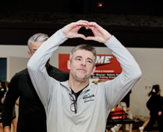 Tony Bryce flashing the heart sign at the crowd during a game
