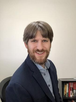 Daniel Westlake from the shoulders up with a white background