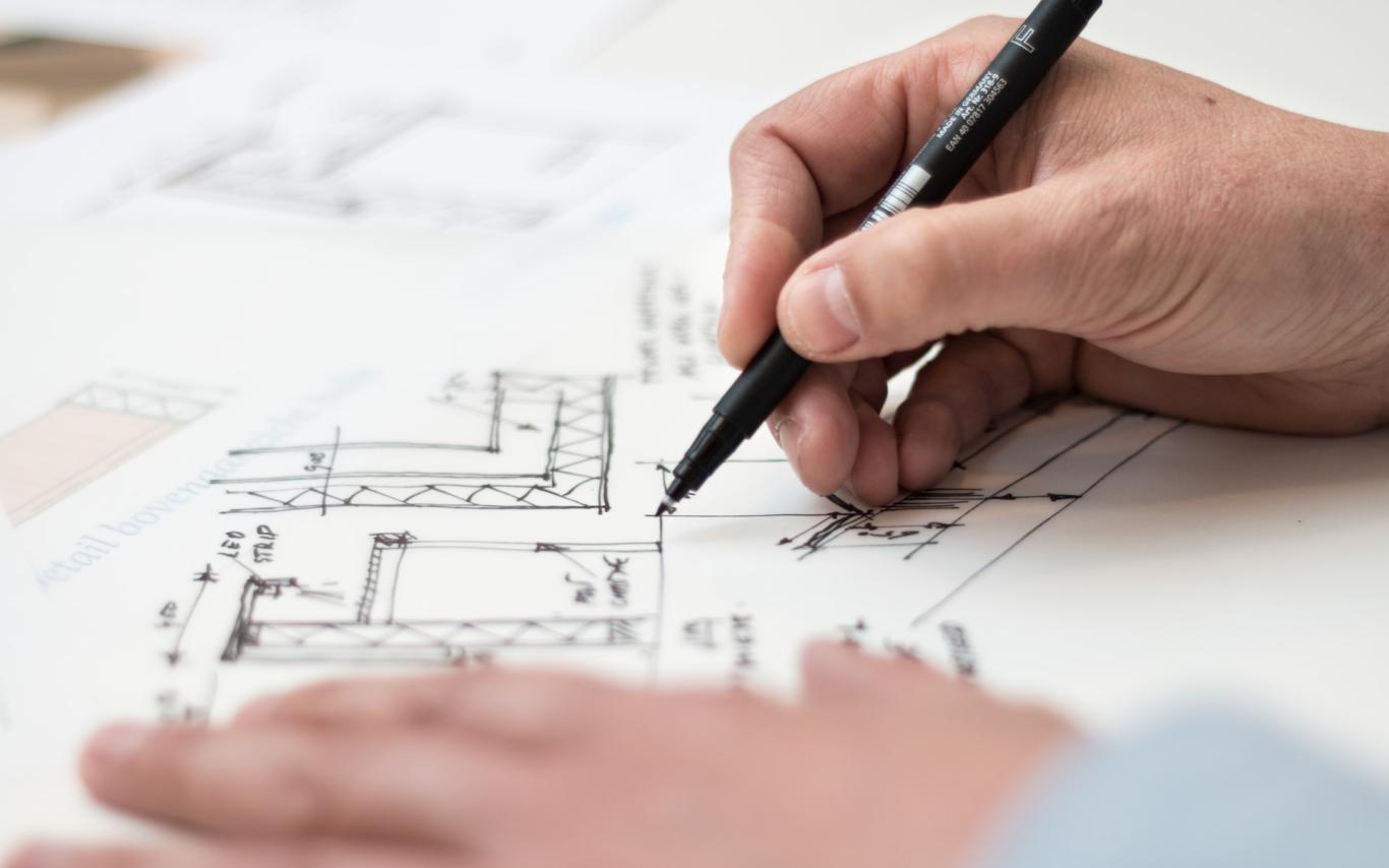 hands sketching an architectural drawing