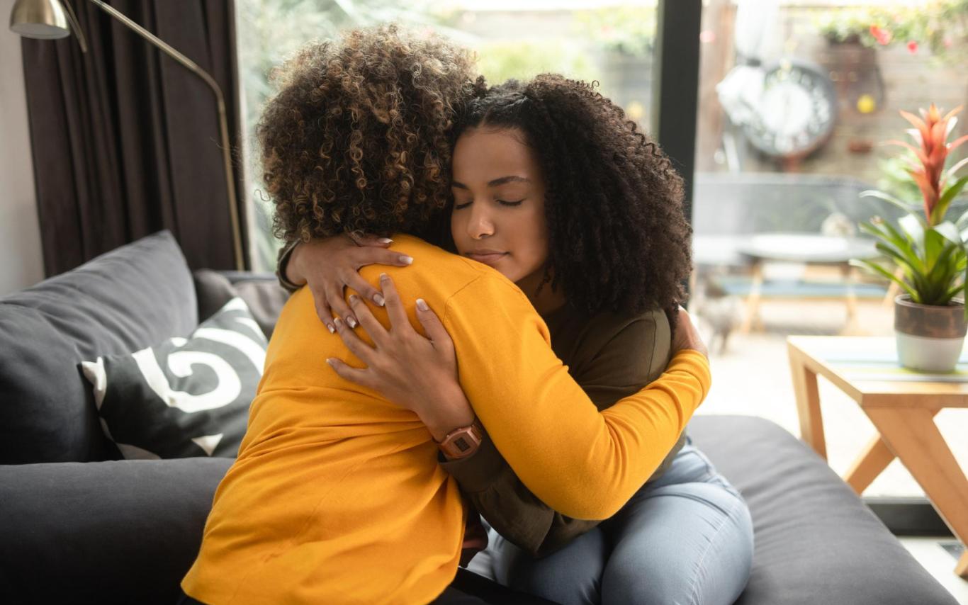 Two women hug