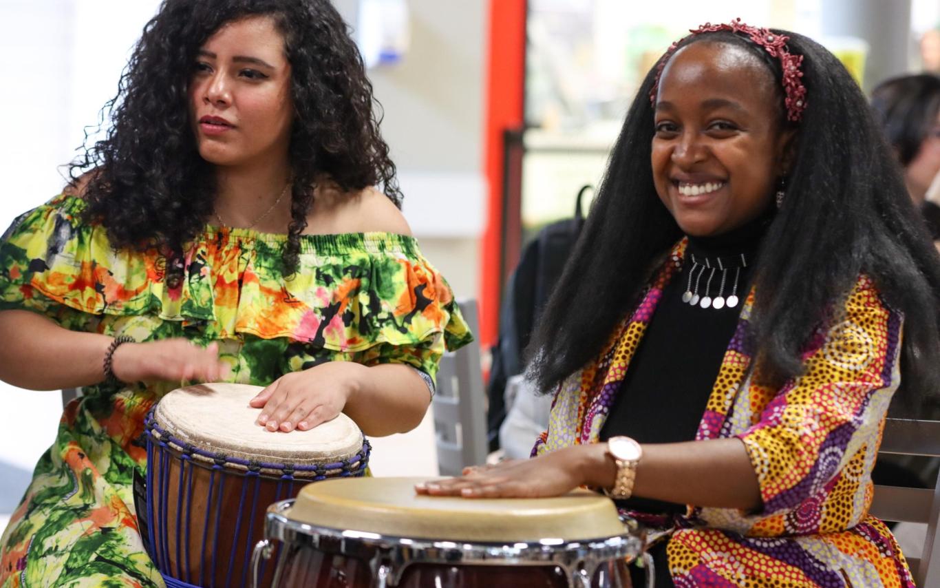 Two women play drums