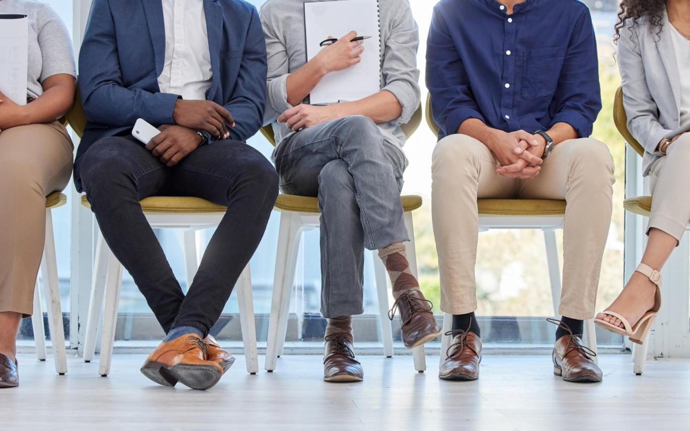 closeup of students' legs dressed in business attire sitting on chairs