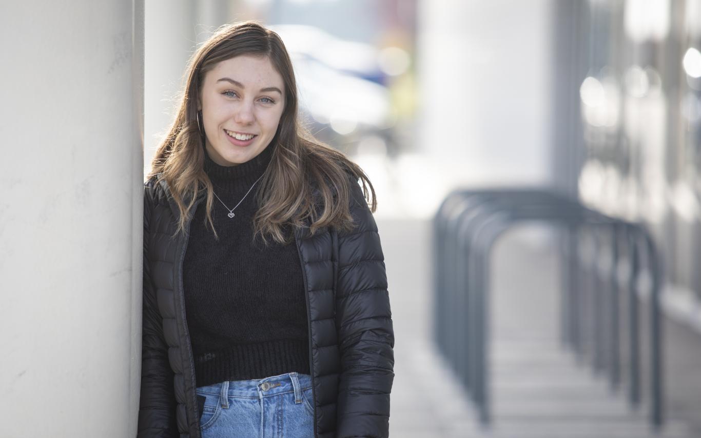 Student posing next to the Health and Science Centre