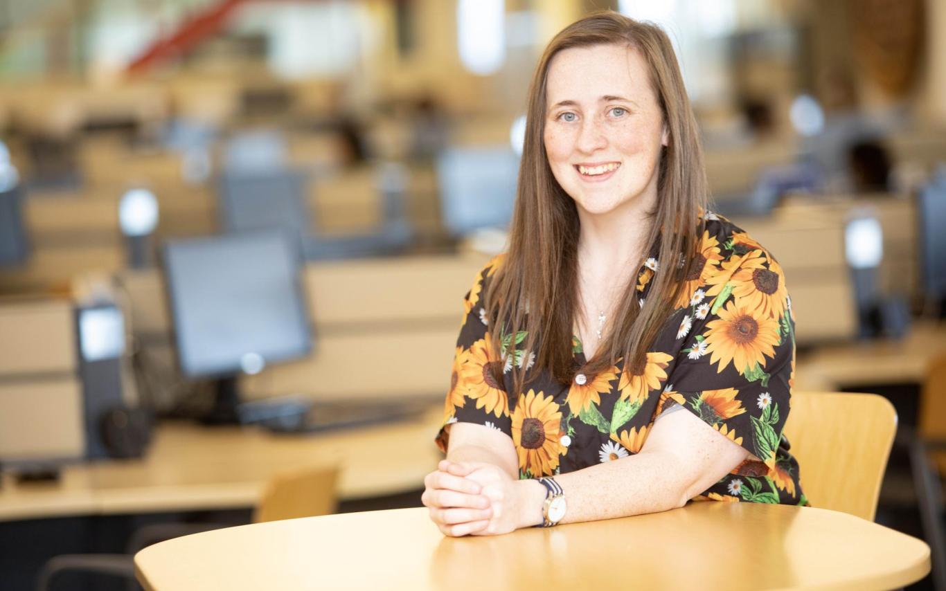 Sherry Wessel sits at a table in the library at VIU's Nanaimo campus