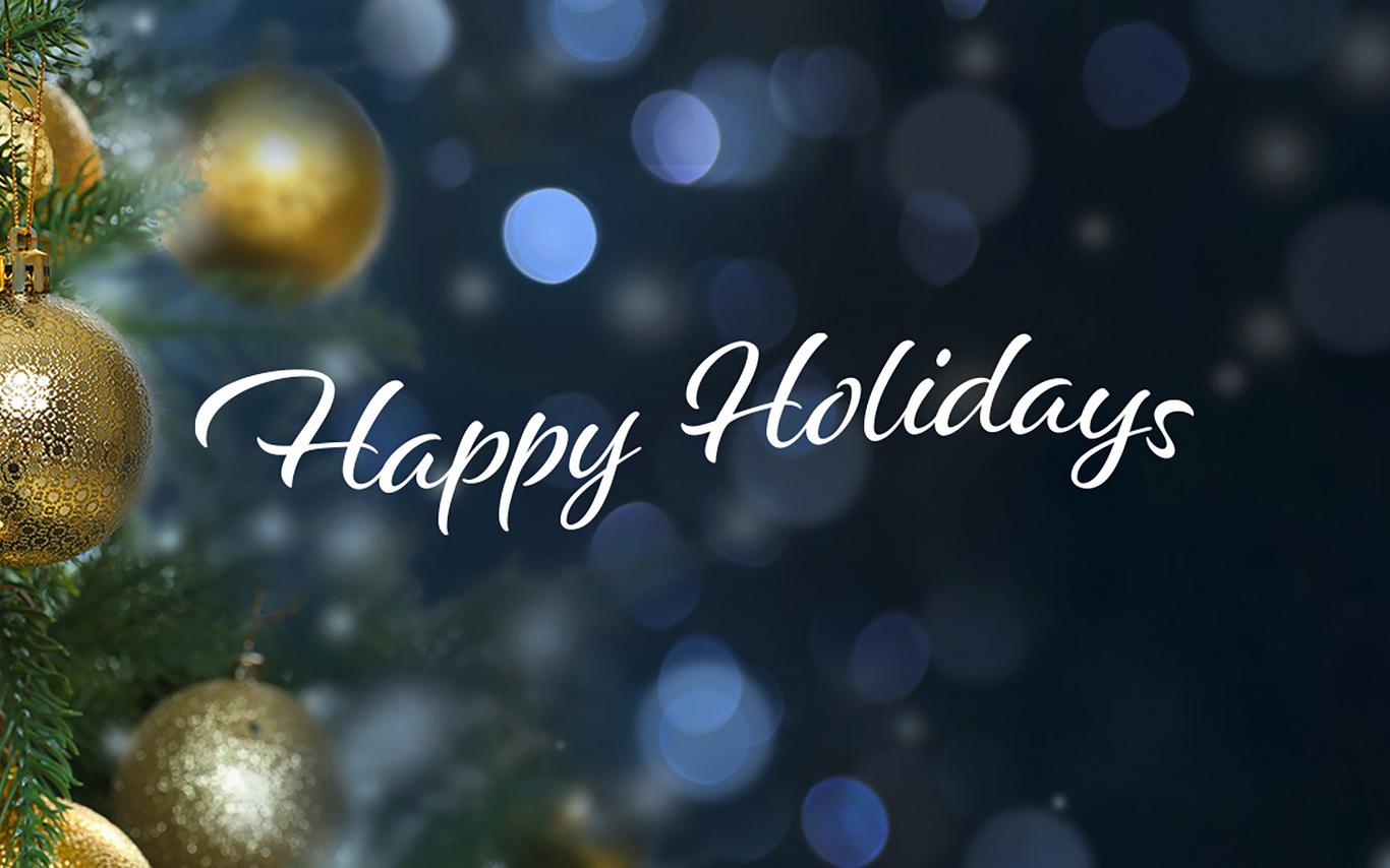 Happy holidays in text with background of ornaments on a tree