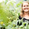Profile of Bianca van der Stoel in a greenhouse surrounded by plants