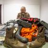 Mike with boots, waterproof jackets and waders laid out on a table