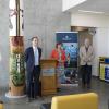 Five people stand in VIU's Health and Science Centre during a media conference.