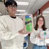 Nathan Pham and Kiara White hold their redesigned product packaging.