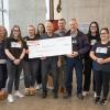 Nursing students pose with a big cheque with Gary O'Brien from Nanaimo RCMP